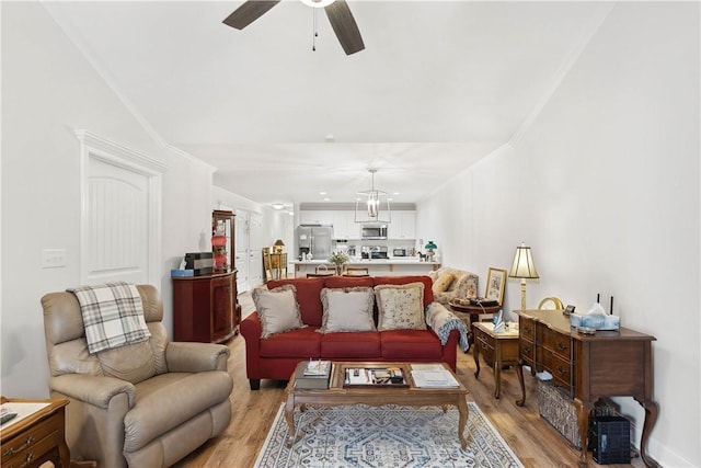 living room featuring light hardwood / wood-style floors and ceiling fan