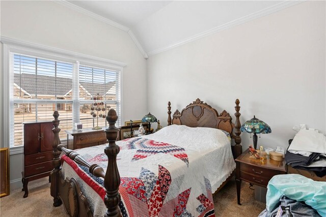 carpeted bedroom with crown molding and vaulted ceiling