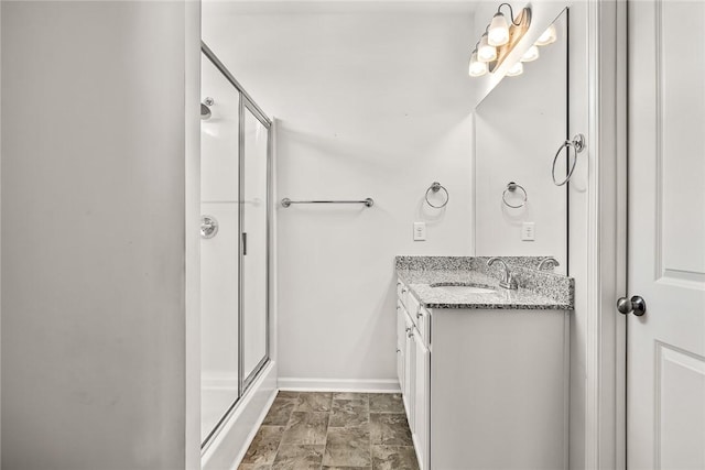 bathroom featuring vanity and a shower with door