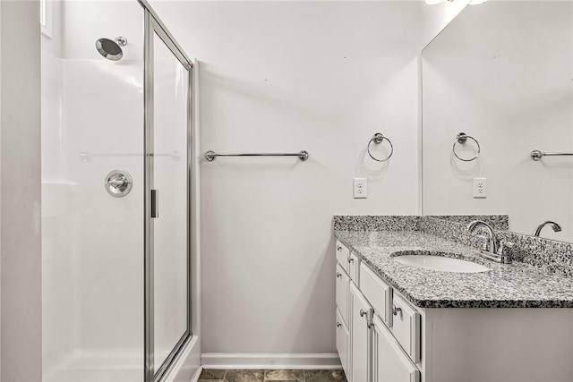 bathroom with a shower with door and vanity