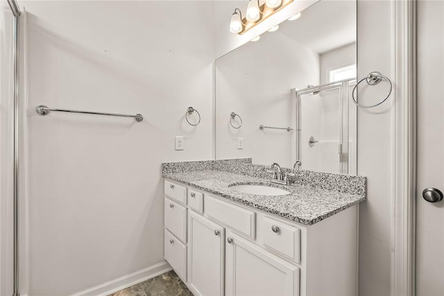 bathroom featuring walk in shower and vanity