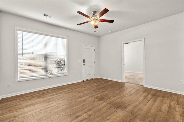 spare room featuring ceiling fan and light hardwood / wood-style flooring