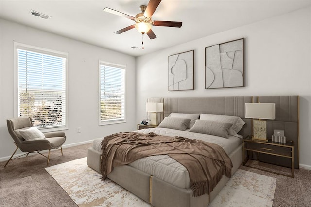 bedroom with ceiling fan and light colored carpet