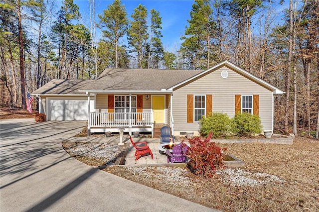 ranch-style home with a garage and covered porch