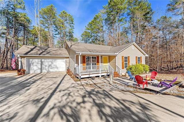 single story home with a garage and covered porch