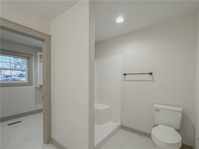 bathroom with tile patterned floors and toilet