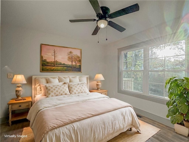 bedroom with hardwood / wood-style flooring and ceiling fan