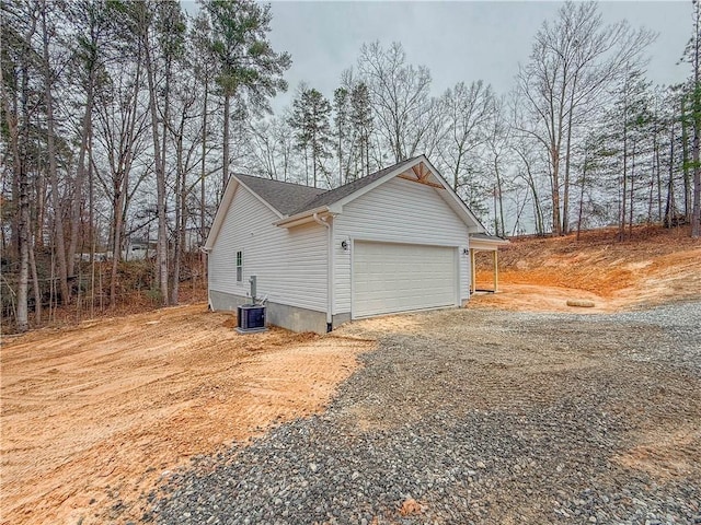 view of home's exterior with a garage and central air condition unit