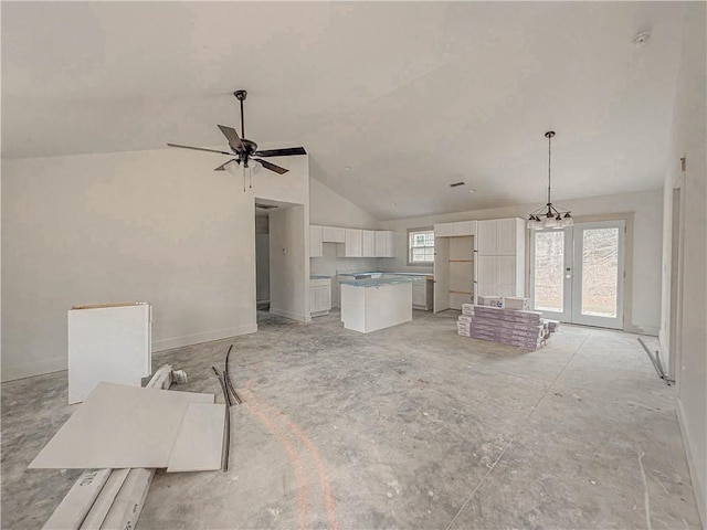 unfurnished living room featuring ceiling fan and lofted ceiling