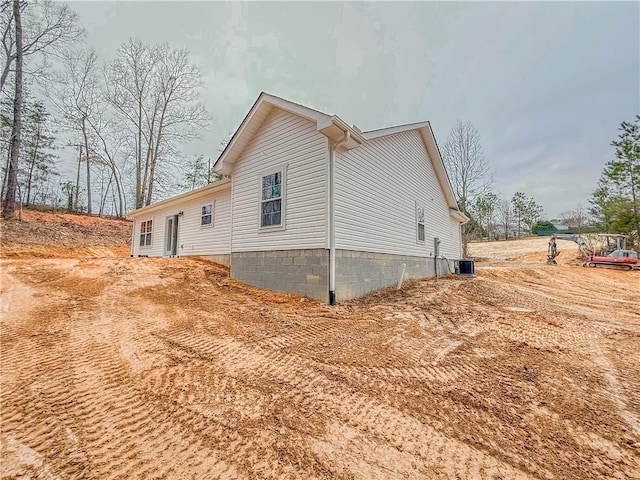 view of side of property with central AC unit