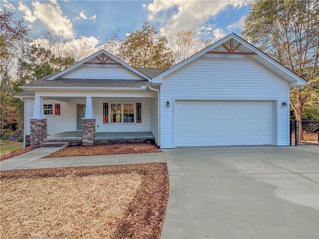 view of front of home featuring a porch and a garage