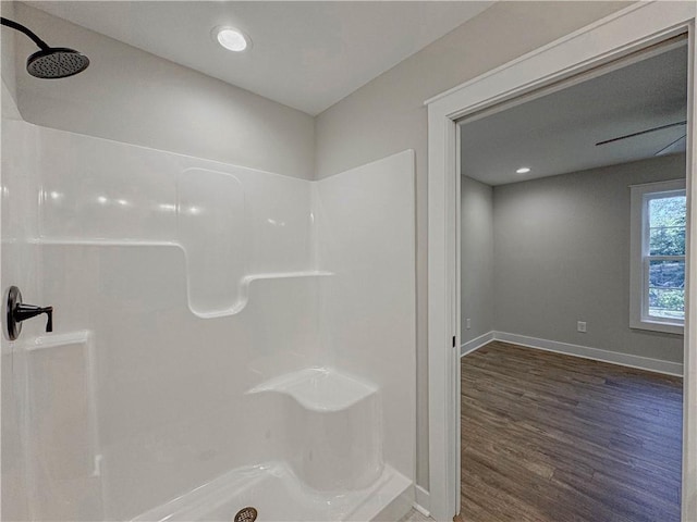 bathroom with hardwood / wood-style floors and walk in shower