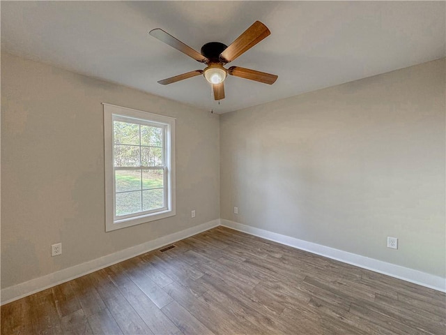 empty room featuring hardwood / wood-style floors and ceiling fan