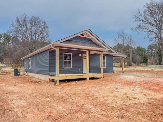 view of front facade with a porch and central AC unit