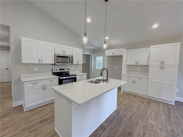 kitchen with white cabinetry, stainless steel appliances, sink, and hanging light fixtures