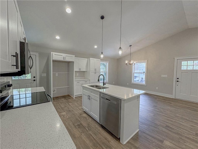 kitchen with pendant lighting, sink, appliances with stainless steel finishes, an island with sink, and white cabinets