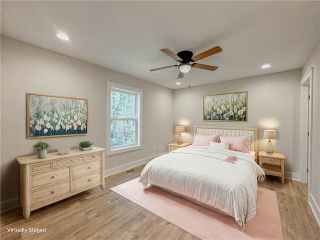 bedroom featuring ceiling fan and light hardwood / wood-style flooring