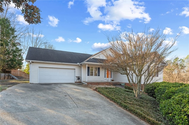 ranch-style house featuring a garage, fence, and concrete driveway