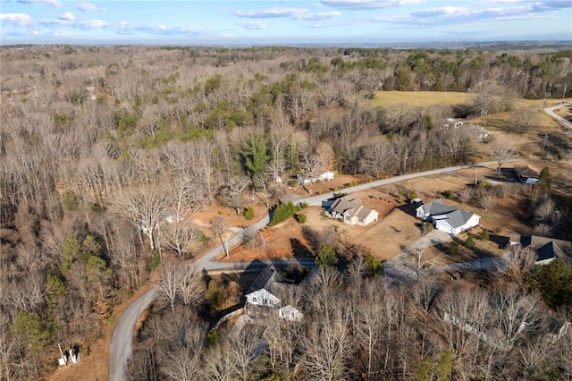 birds eye view of property with a view of trees