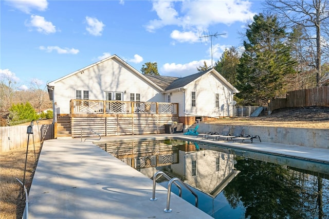 back of property featuring a pool side deck