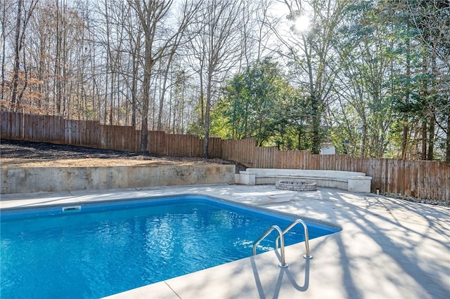 view of swimming pool featuring a fenced backyard, a fenced in pool, and a patio