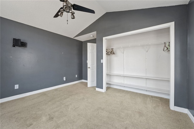 unfurnished bedroom featuring carpet floors, vaulted ceiling, baseboards, and ceiling fan