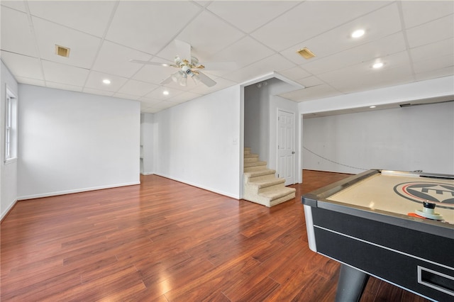 playroom with a ceiling fan, visible vents, a drop ceiling, and wood finished floors