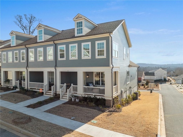 view of front facade featuring central AC and a porch