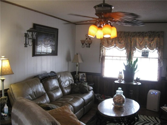 living room featuring ornamental molding and ceiling fan