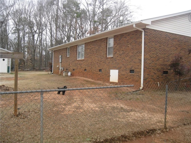 view of side of home with central AC unit