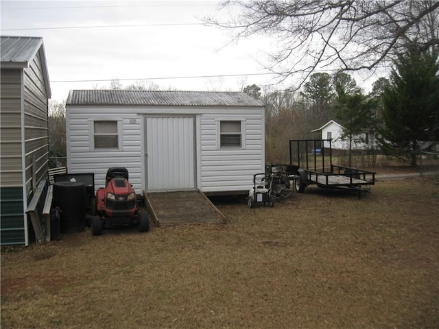 view of outbuilding featuring a yard