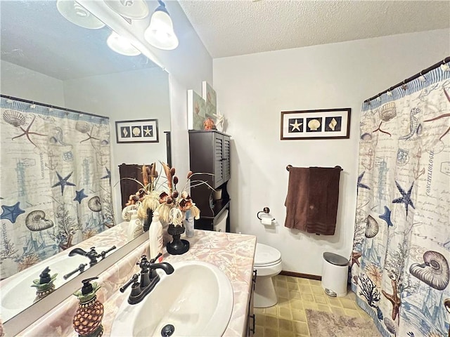 full bathroom with baseboards, a textured ceiling, toilet, and vanity