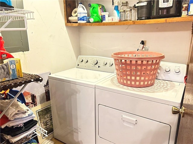 clothes washing area featuring washer and dryer and laundry area