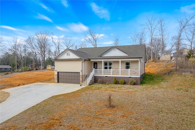 view of front of home with a garage, covered porch, and a front lawn