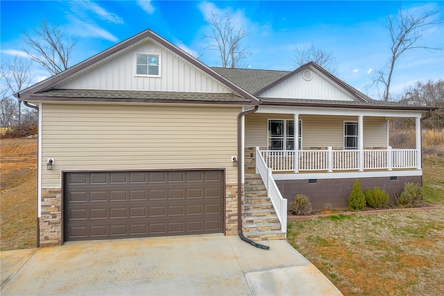 view of front of home featuring a porch, a garage, and a front lawn