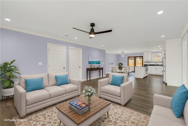 living room featuring ornamental molding, sink, ceiling fan, and light hardwood / wood-style flooring