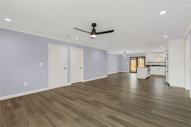 unfurnished living room featuring crown molding, ceiling fan, and dark hardwood / wood-style flooring