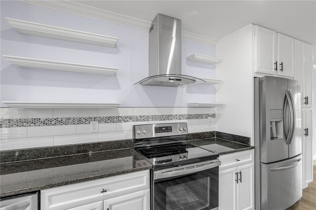 kitchen featuring white cabinetry, stainless steel appliances, dark stone counters, and wall chimney exhaust hood