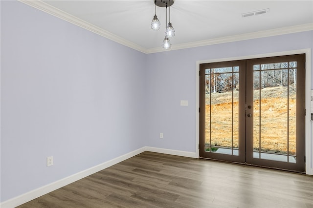 spare room with ornamental molding, wood-type flooring, and french doors