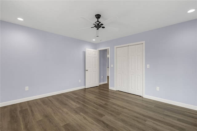 unfurnished bedroom with ceiling fan, dark hardwood / wood-style flooring, and a closet