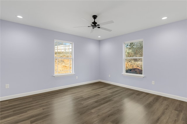 unfurnished room featuring dark wood-type flooring, ceiling fan, and a healthy amount of sunlight