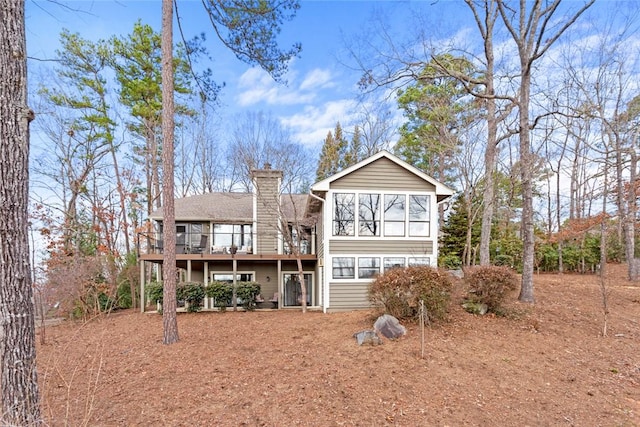 rear view of property with a wooden deck