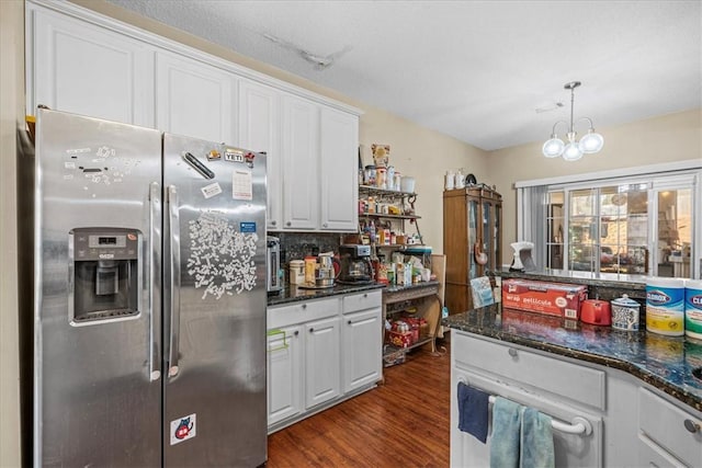 kitchen with dark wood-type flooring, an inviting chandelier, stainless steel fridge with ice dispenser, hanging light fixtures, and white cabinets