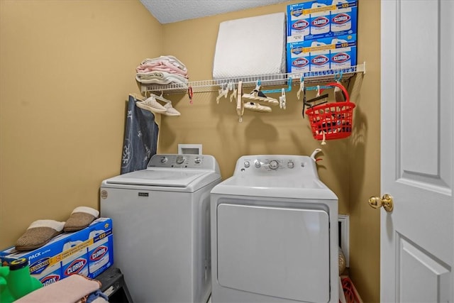 clothes washing area with separate washer and dryer