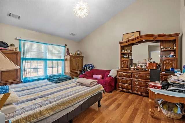 bedroom featuring vaulted ceiling and light hardwood / wood-style floors