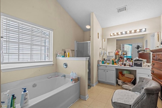 bathroom featuring lofted ceiling, tile patterned flooring, vanity, a textured ceiling, and shower with separate bathtub