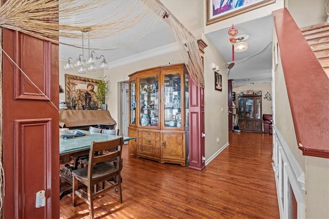 dining room featuring an inviting chandelier, crown molding, and dark wood-type flooring