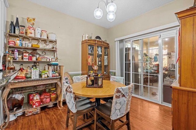 dining room featuring hardwood / wood-style floors and a notable chandelier