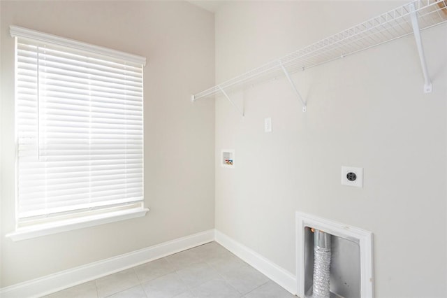 clothes washing area with washer hookup, hookup for an electric dryer, and light tile patterned floors