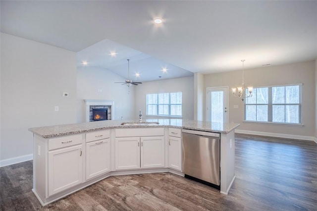 kitchen with white cabinetry, sink, dishwasher, and a center island with sink